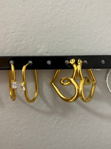 Customer's two pairs of gold earrings from the Valentines Bundle, including heart-shaped hoops and small hoops with gems.