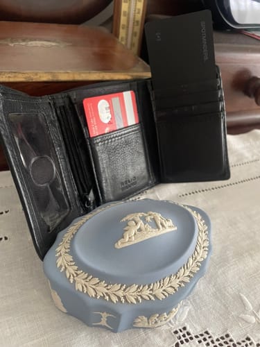 Customer's black SPOTMINDERS Tracking Card sticking out of a card slot in an open black wallet.