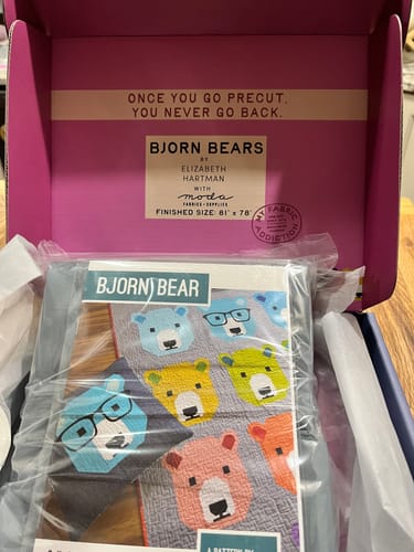Customer's Bjorn Bear Quilt Kit in its branded pink box, showing the pattern through plastic.