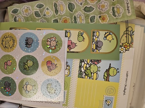 Reviewer's collection of 'Cute Critters' sticker sheets from their subscription, laid out to show the various designs.