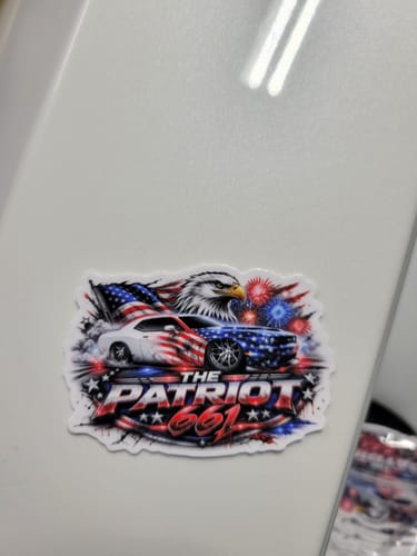 Customer's custom vinyl sticker with a patriotic design featuring cars, a bald eagle, and the text "THE PATRIOT 661".