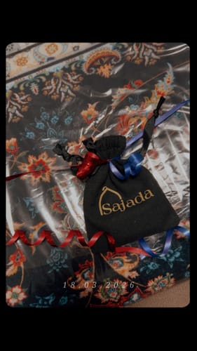 Customer's Firdaws Padded Prayer Mat with a dark, floral pattern, still in its packaging.