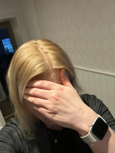 Customer showing their warm, blonde hair after using the Sunkissed Starter Kit.
