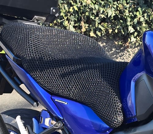Reviewer's black mesh Wind Rider Seat Cover shown fitted onto their blue motorcycle.