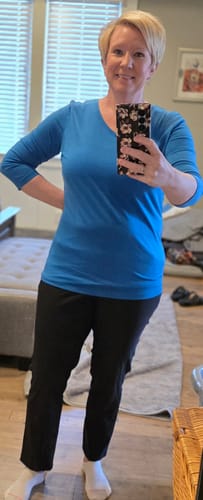 Customer showing the full-length fit of the black Nicole Ankle Pants in a mirror selfie.