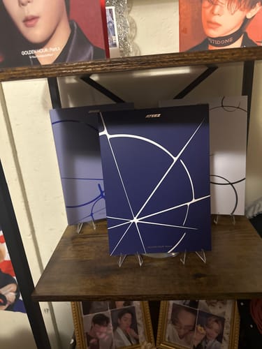 Customer's ATEEZ GOLDEN HOUR album set, showing three different cover versions displayed on a shelf.