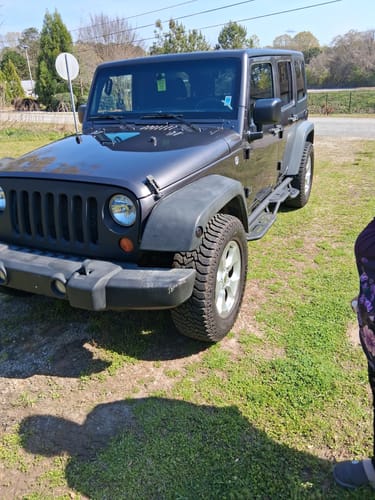 Customer's black Jeep with wheel spacers installed, showing a wider wheel stance and improved tire clearance.