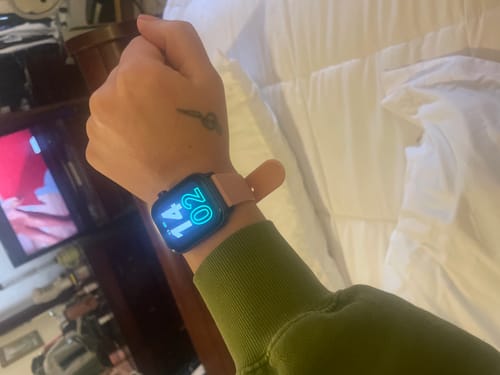 Customer showing their Gard Pro Health Smartwatch 2+ with a pink band and a lit screen on their wrist.