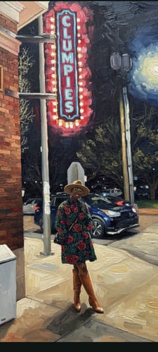 Reviewer looking chic in the FAYO AFRICAN PRINT SHIRT DRESS, styled with a hat and tall boots on a city street at night.