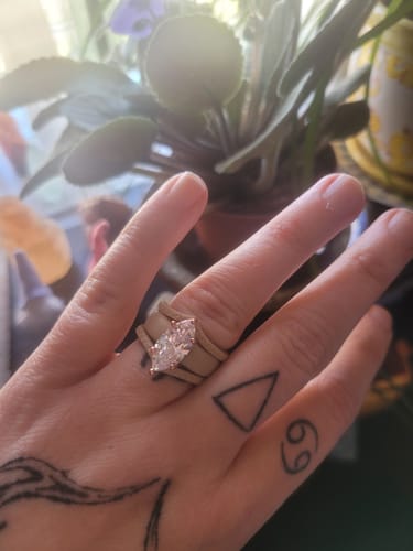 Reviewer's hand wearing the GlowStone Collection stackable silicone ring with a shiny marquise-cut stone.