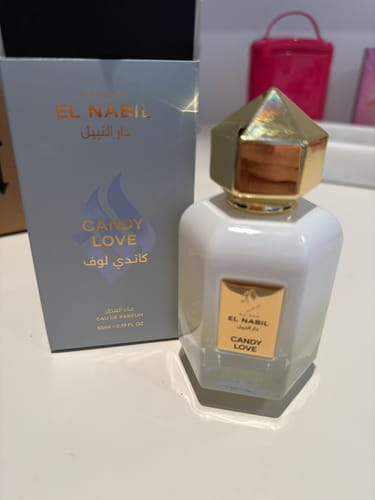 Customer's white CANDY LOVE perfume bottle with a gold cap, shown next to its blue box.