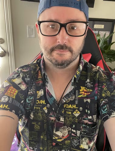 Close-up of a reviewer wearing the 'Flux Overload' shirt, showing off its detailed and colorful 'Back to the Future' print.