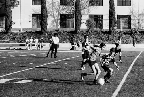 Customer's sharp black and white action shot of a youth soccer game, taken with the Simera 75mm lens.