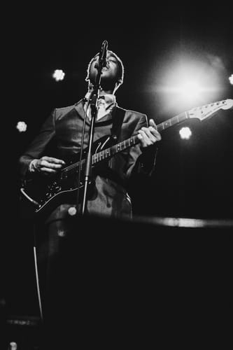 Reviewer's live music photo of a musician performing on stage, taken with the Simera 28mm f/1.4 lens.