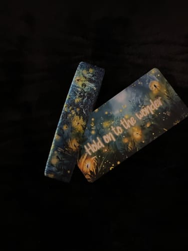 Customer's Hold on to the Wonder Bracelet and its pretty, matching card displayed on a dark surface.