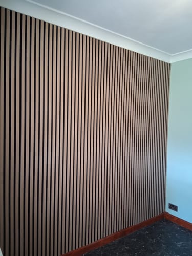 Customer's accent wall fully covered in light brown Premium Acoustic Slatted Wall Panels.