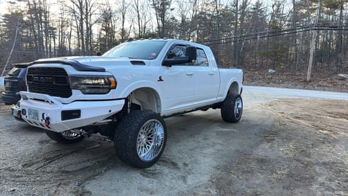 Reviewer's lifted white Dodge Ram 2500 showing the leveled stance from the 3-inch leveling spacers.