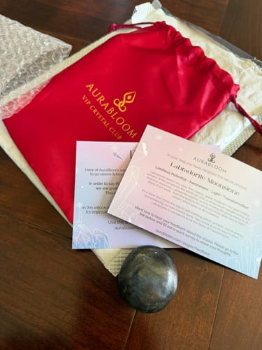 Reviewer's monthly crystal from the VIP Crystal Club with its red pouch and informational cards.