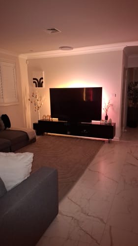 Customer's Mocha Mellow Mat in a cozy living room with ambient TV backlighting.