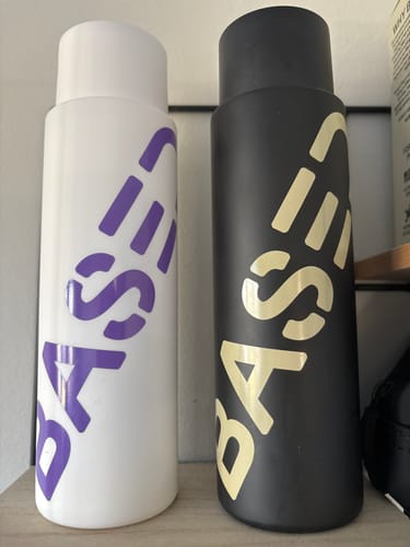 Customer's Shower Duo, showing the white shampoo bottle and the black conditioner bottle standing side by side on a shelf.