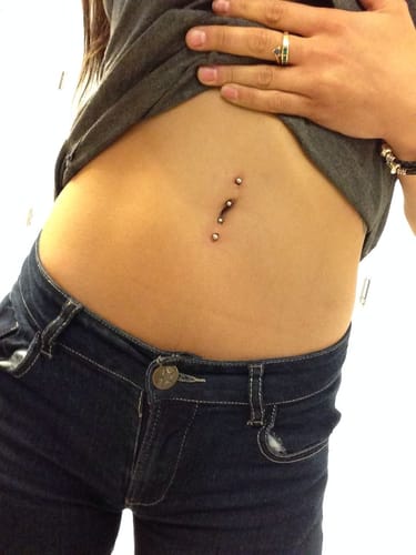 Close-up of a reviewer wearing the comfortable Titanium Duo Gem Body Jewellery in a surface piercing on their abdomen.