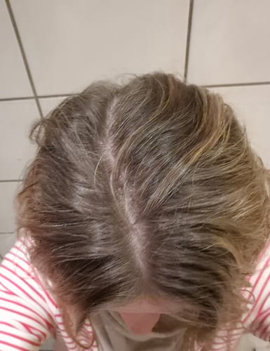 Reviewer's hair after using the Grey Cover product, showing visible grey roots along the part.