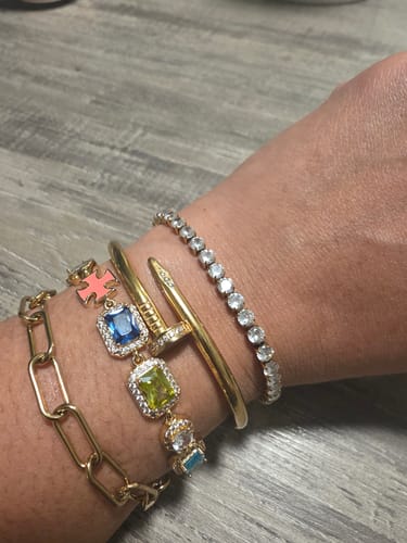 Customer's wrist, showing the sparkly Martina® Classic Tennis Bracelet layered with other bracelets.