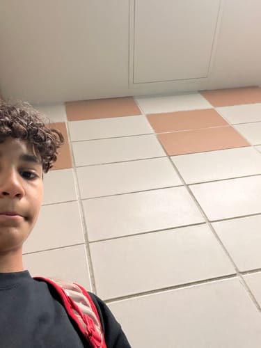 Reviewer with healthy-looking curly hair after using the Shower Duo.