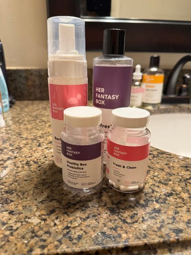 Customer's Full Feminine Hygiene Routine products, including wash, foam, and capsules, on a bathroom counter.