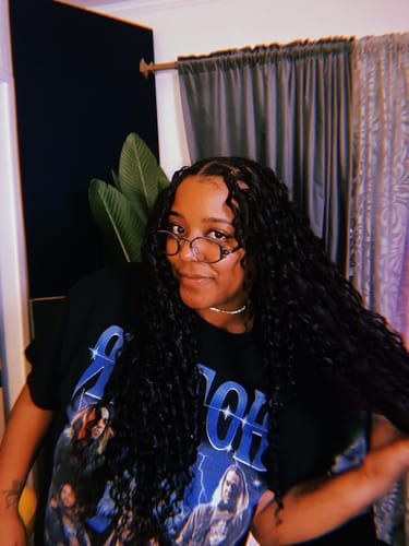 Reviewer smiling, showing their long, wavy Human Crochet Hair Deep Wave installation in a room.