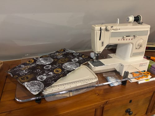 Customer's clear Sew Steady extension table fitted to a vintage Singer sewing machine on a wooden desk.