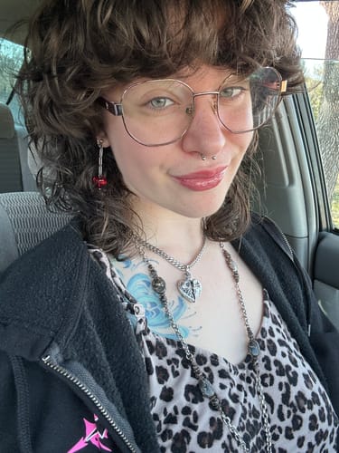 Close-up of a customer wearing the Cosmic Heart Pendant on a silver Cuban chain.