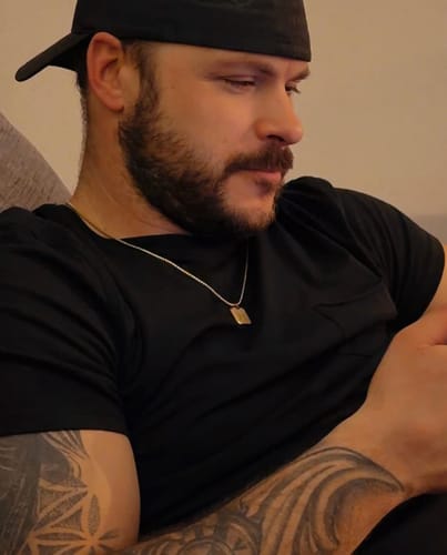 Customer wearing the Mini Matte Modern Dog Tag necklace against a black t-shirt.