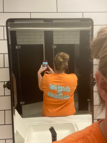 Reviewer taking a mirror selfie showing the cloud clip holding their blonde hair in a bun.