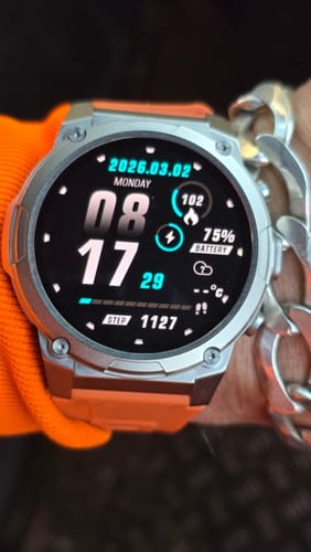 Close-up of a reviewer's Gard Pro Ultra 3 watch on their wrist, showing the digital display and rugged silver case.