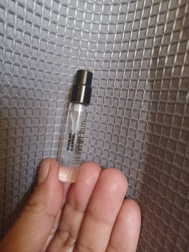 Customer holding the small 2ml sample vial of Bois De Santal Eau de Parfum.