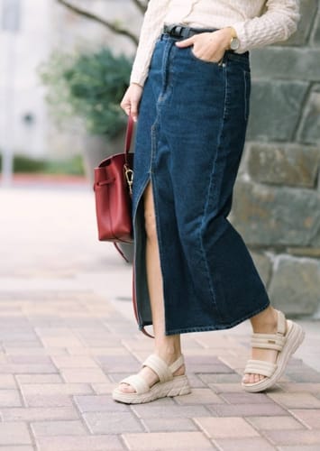 Customer walks on a sidewalk in beige platform sandals, showing their style in a review for The Align.