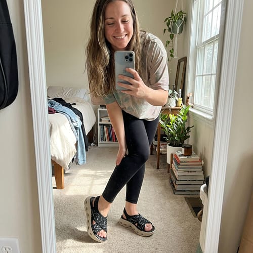 Customer shows off her black patterned Energy sandals with platform soles in a mirror selfie.