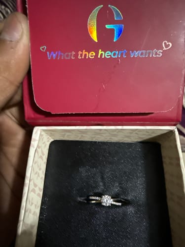 Customer holding open a red jewelry box showing the Silver Glittering Ring with a studded two-layer band.