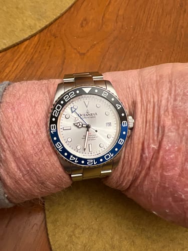 Customer's Oceaneva diver watch on their wrist, showing the silver dial and two-tone blue and black bezel.