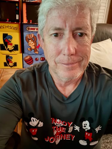 A close-up of a customer wearing the grey 'Enjoy the Journey' long-sleeve performance tee.