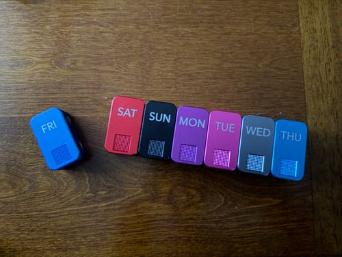 Customer's colorful MagNano Case set on a wooden table, with the Friday case separated from the rest.
