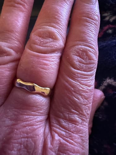 Close-up: Reviewer's hand showing the unique design of the gold Bamboo Ring.