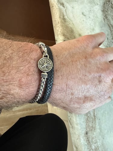 Customer wearing the Compass Urn Bracelet, shown as an upgrade next to their previous leather bracelet.