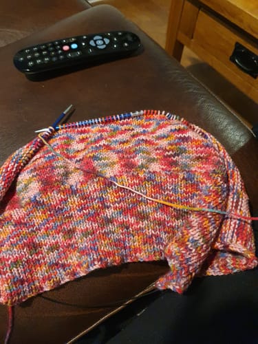 Reviewer's colorful knitting project in progress using yarn from the Ladies Mystery Knitting Box.