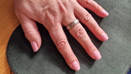 Reviewer's hand with a neat manicure featuring the light pink 'Ballerina' Holy Gels.