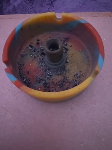 Customer's colorful ashtray with ashes after smoking The Summit preroll.