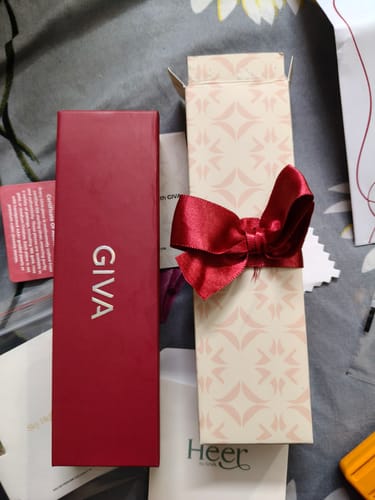 Reviewer shows the red branded box and patterned gift box for the Silver Bohemian Beaded Anklet.