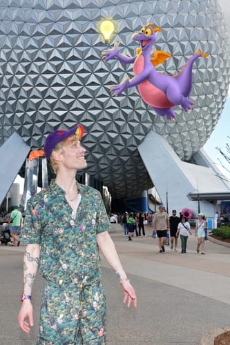 Reviewer wearing the printed "I Found the Snipe" Hybrid Shorts with the matching shirt at a theme park.