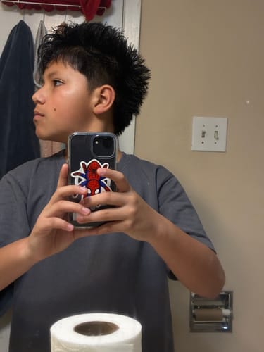 Reviewer's side profile shows a spiky mohawk hairstyle held in place with Hair Clay.